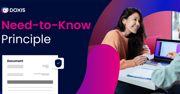 Two people discussing the Need-to-Know Principle with a laptop and documents on the table.